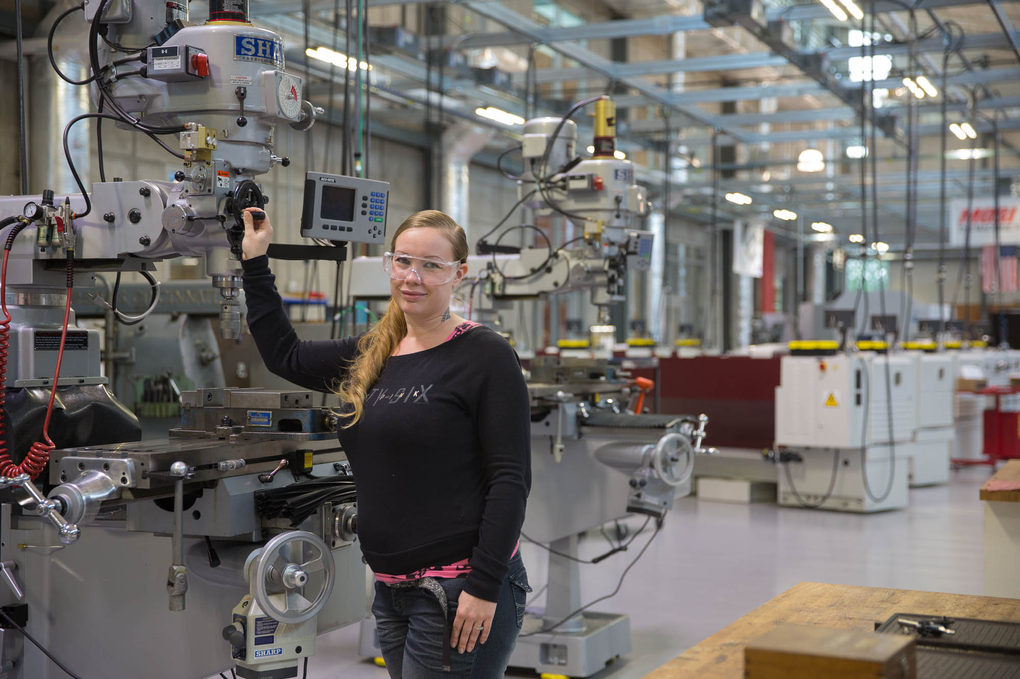 Woman working on a CNC machine